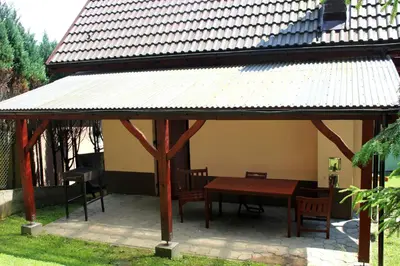 a gazebo with a table and chairs under it at Zawoja Chaty Górskie D4 in Zawoja