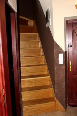 a stairway with wooden steps next to a door at Zawoja Chaty Górskie D4 in Zawoja