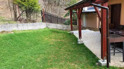 a yard with a gazebo next to a house at Zawoja Chaty Górskie D4 in Zawoja