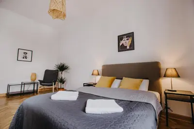 a bedroom with a bed with two pillows on it at Michałowskiego 11 in Kraków