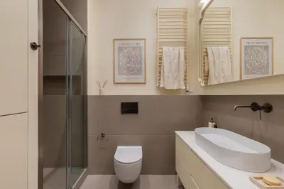 a bathroom with a sink and a toilet and a shower at Michałowskiego 11 in Kraków