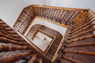 an overhead view of a wooden stairs with a mirror at Michałowskiego 11 in Kraków