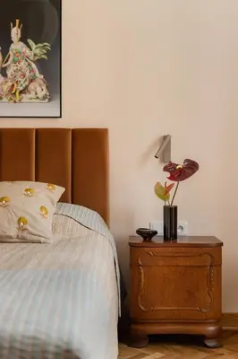 a bedroom with a bed and a nightstand with a lamp at Michałowskiego 11 in Kraków