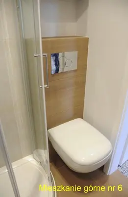 a bathroom with a toilet and a shower at Rondo Mogilskie Apartment in Kraków