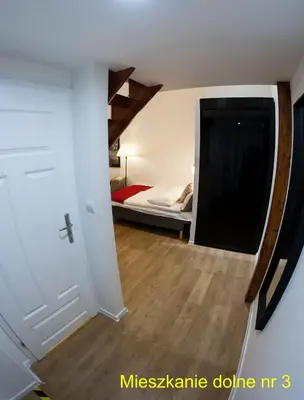 a room with a bed and a room with a door at Rondo Mogilskie Apartment in Kraków