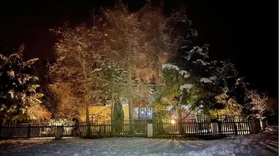 a fence in front of a house at night at Góralska Czarcia Chata pod Jałowcem in Stryszawa