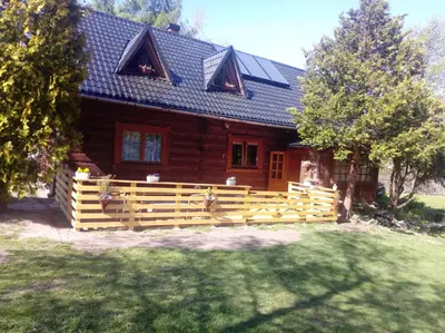 a wooden house with a fence in front of it at Góralska Czarcia Chata pod Jałowcem in Stryszawa