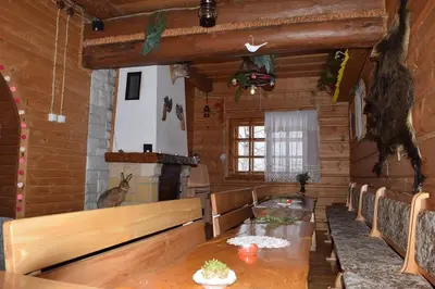 a room with a table in a wooden cabin at Góralska Czarcia Chata pod Jałowcem in Stryszawa