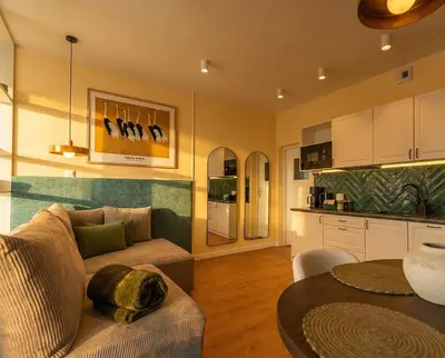 a hotel room with a bed and a desk and a chair at City Lights Apartments in Kraków