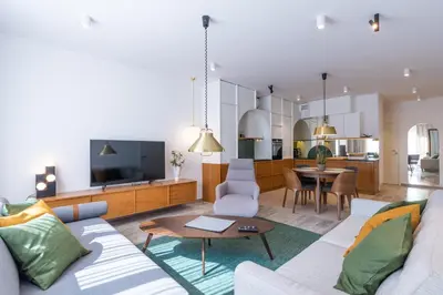 a living room with a couch and a television at City Lights Apartments in Kraków