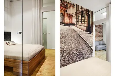 a bedroom with a bed and a brick hallway at Krakow For You Main Square Apartments in Kraków