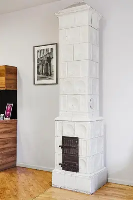 a white brick fireplace in a living room at Krakow For You Main Square Apartments in Kraków