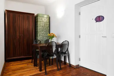 a dining room with a table and black chairs at Krakow For You Main Square Apartments in Kraków
