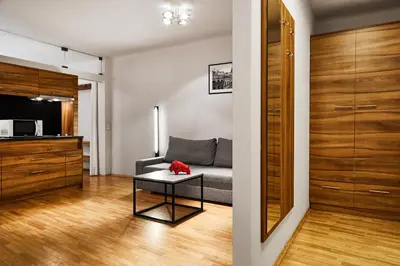 a living room with a couch and a table at Krakow For You Main Square Apartments in Kraków