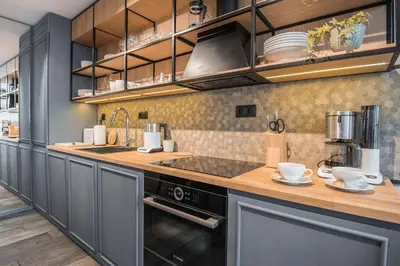 a kitchen with wooden cabinets and a counter top at Stradom15 Apartments in Kraków