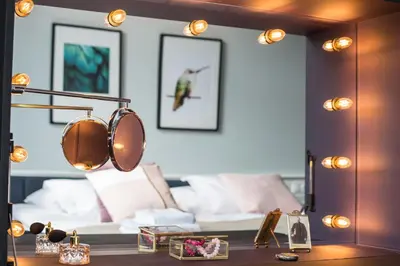 a mirror in a living room with a bed at Stradom15 Apartments in Kraków