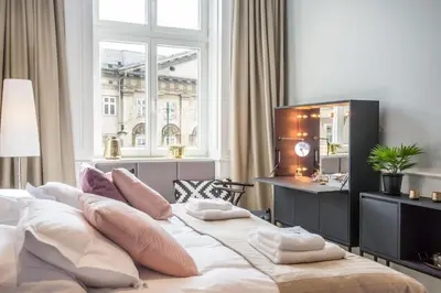 a bedroom with a large bed with pillows on it at Stradom15 Apartments in Kraków
