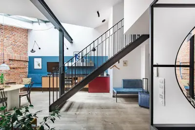 a staircase in a room with a table and chairs at Stradom15 Apartments in Kraków