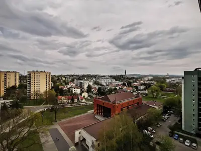 a view of a city with a building and buildings at Sky Apartments - Łagiewniki in Kraków