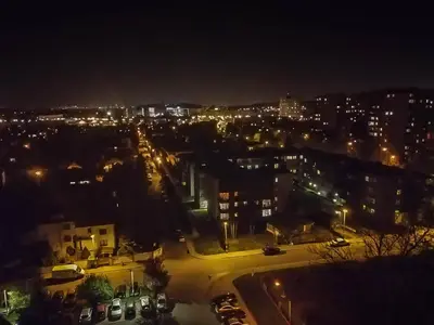 a view of a city at night with lights at Sky Apartments - Łagiewniki in Kraków
