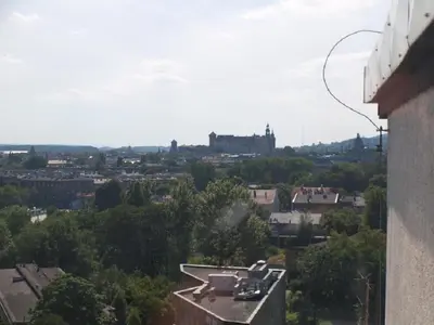a view of a city with a castle in the distance at Studio Aleja Pokoju II in Kraków
