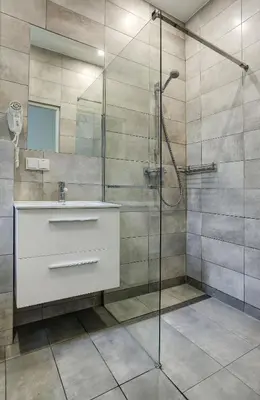 a bathroom with a sink and a shower at Grace Apartments in Kraków