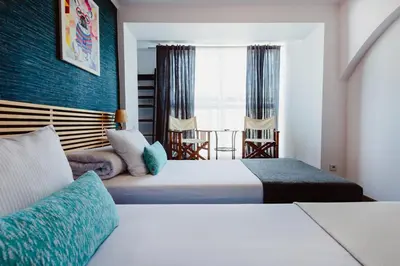a hotel room with two beds and a window at Kings City - Zyblikiewicza Apartment in Kraków