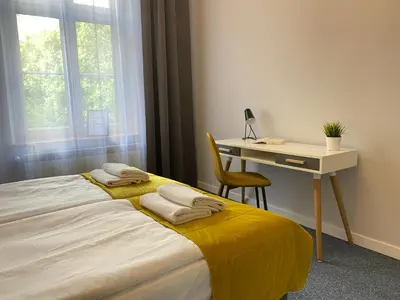 a bedroom with a bed and a desk and a table and chair at Old Town Residence Bis in Kraków