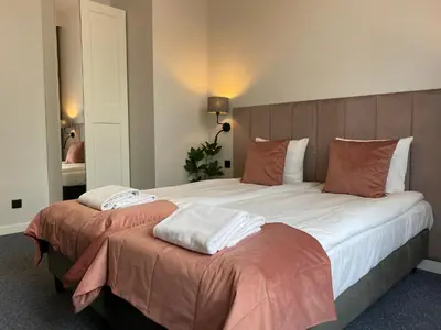 a hotel room with two beds with towels on them at Old Town Residence Bis in Kraków