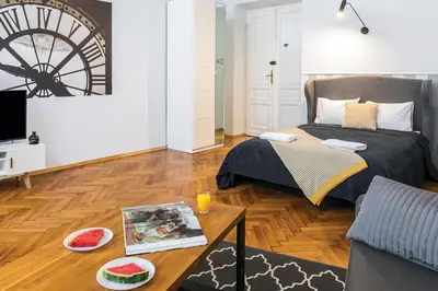 a living room with a bed and a coffee table at Old Town Residence Bis in Kraków