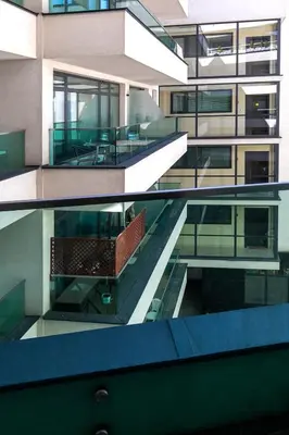 two views of a building with a balcony at Apartamenty Lucky 13 in Kraków