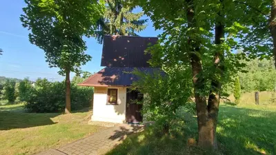 a small white house with a red roof at Zajazd Turystyczny Stara Gawęda in Czechówka