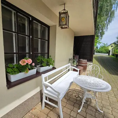 a patio with a white bench and a table at Zajazd Turystyczny Stara Gawęda in Czechówka
