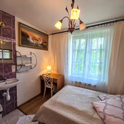 a bedroom with a bed and a sink and a window at Zajazd Turystyczny Stara Gawęda in Czechówka