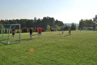 a group of people playing soccer on a field at Zajazd Turystyczny Stara Gawęda in Czechówka