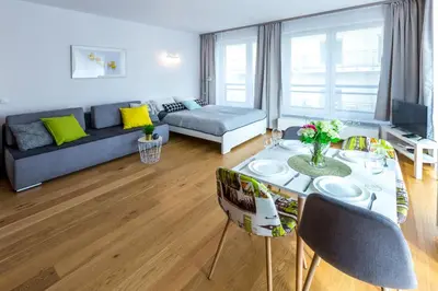 a living room with a table and a couch at Arianska Residence in Kraków