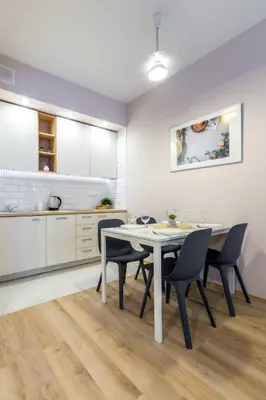 a kitchen and dining room with a table and chairs at Arianska Residence in Kraków