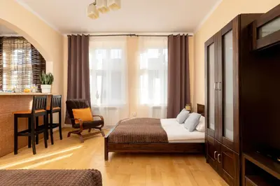a hotel room with a bed and a table and chairs at Caffe latte apartment in Kraków