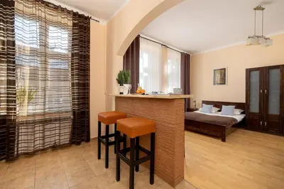 a living room with a bar and a couch at Caffe latte apartment in Kraków