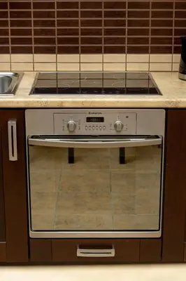 a stove in a kitchen with a counter at Caffe latte apartment in Kraków