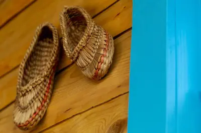 a fence covered in snow in front of a house at Chata drewniana Stefanówka in Ślemień