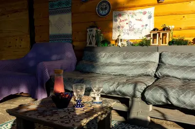 a patio with chairs and a table and a building at Chata drewniana Stefanówka in Ślemień