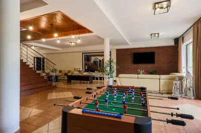 a living room with a pool table in the middle at Hotel Łaziska in Czchów