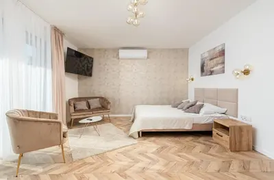 a bedroom with a bed and a chair at Hotel Łaziska in Czchów