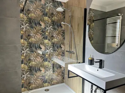 a bathroom with a sink and a mirror at Apartament Francuzka in Kraków