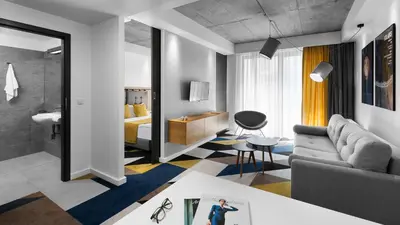 a living room with a couch and a bedroom at Lwowska 1 in Kraków