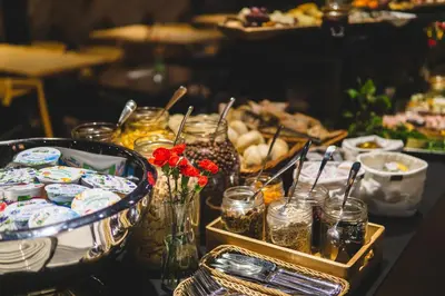 a table topped with plates and jars of food at Lwowska 1 in Kraków