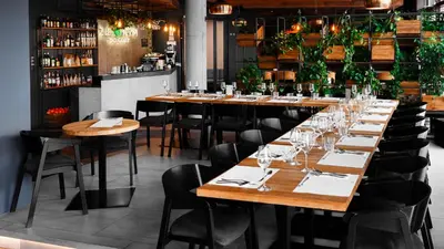 a long table in a restaurant with glasses on it at Lwowska 1 in Kraków