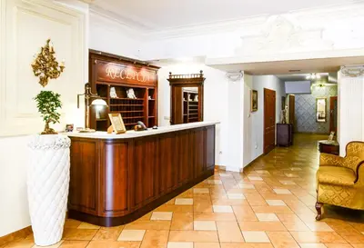 a lobby with a bar in the middle of a room at Dworek Emilli in Wieliczka