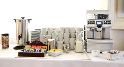 a kitchen counter with a coffee making machine and a coffeeacist at Dworek Emilli in Wieliczka